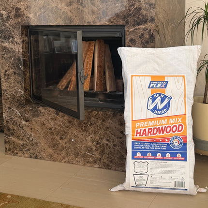 Marble fireplace with a fire burning inside, a kiln dried firewood MEGA Bag on the floor