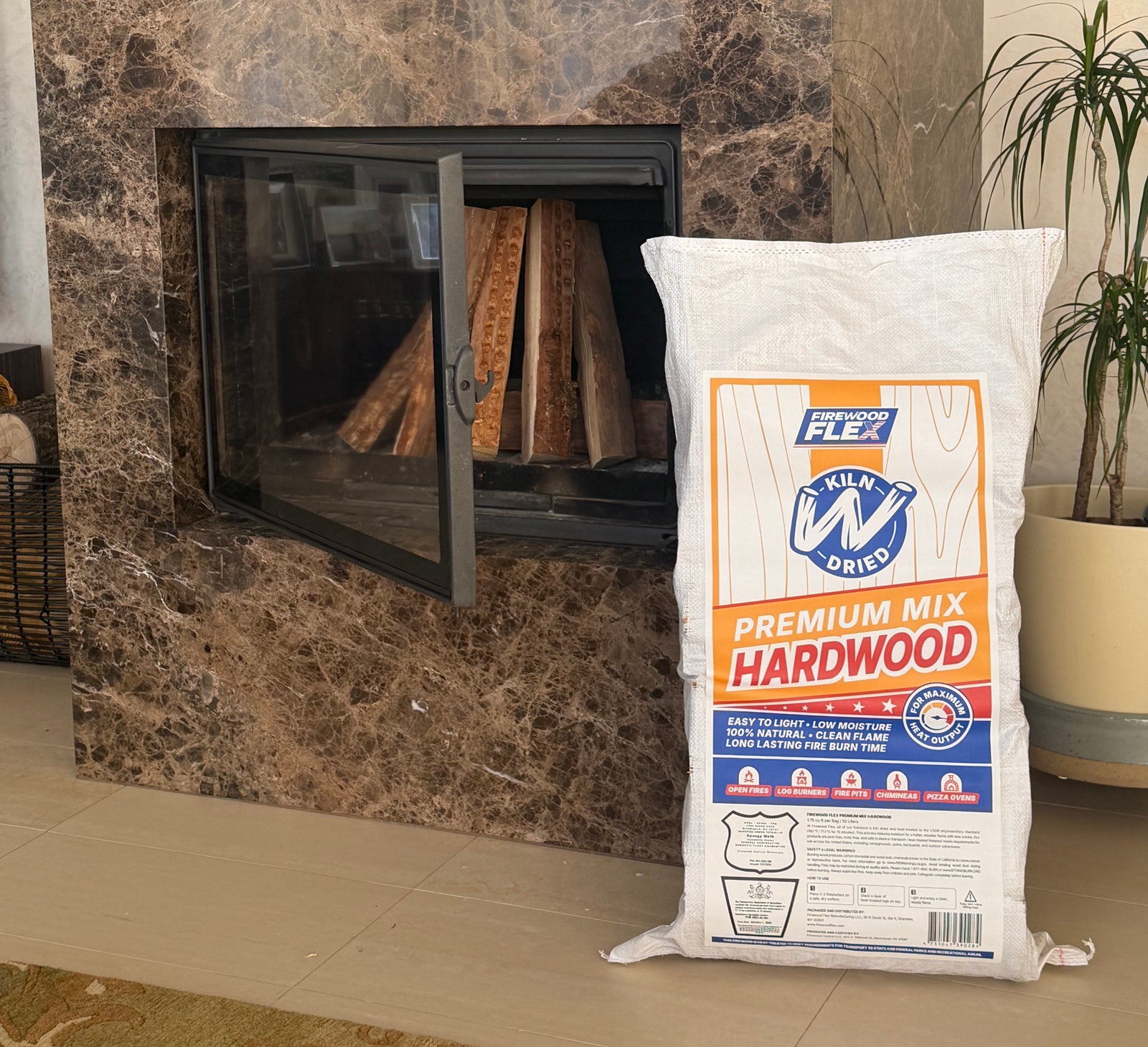 Marble fireplace with a fire burning inside, a kiln dried firewood MEGA Bag on the floor